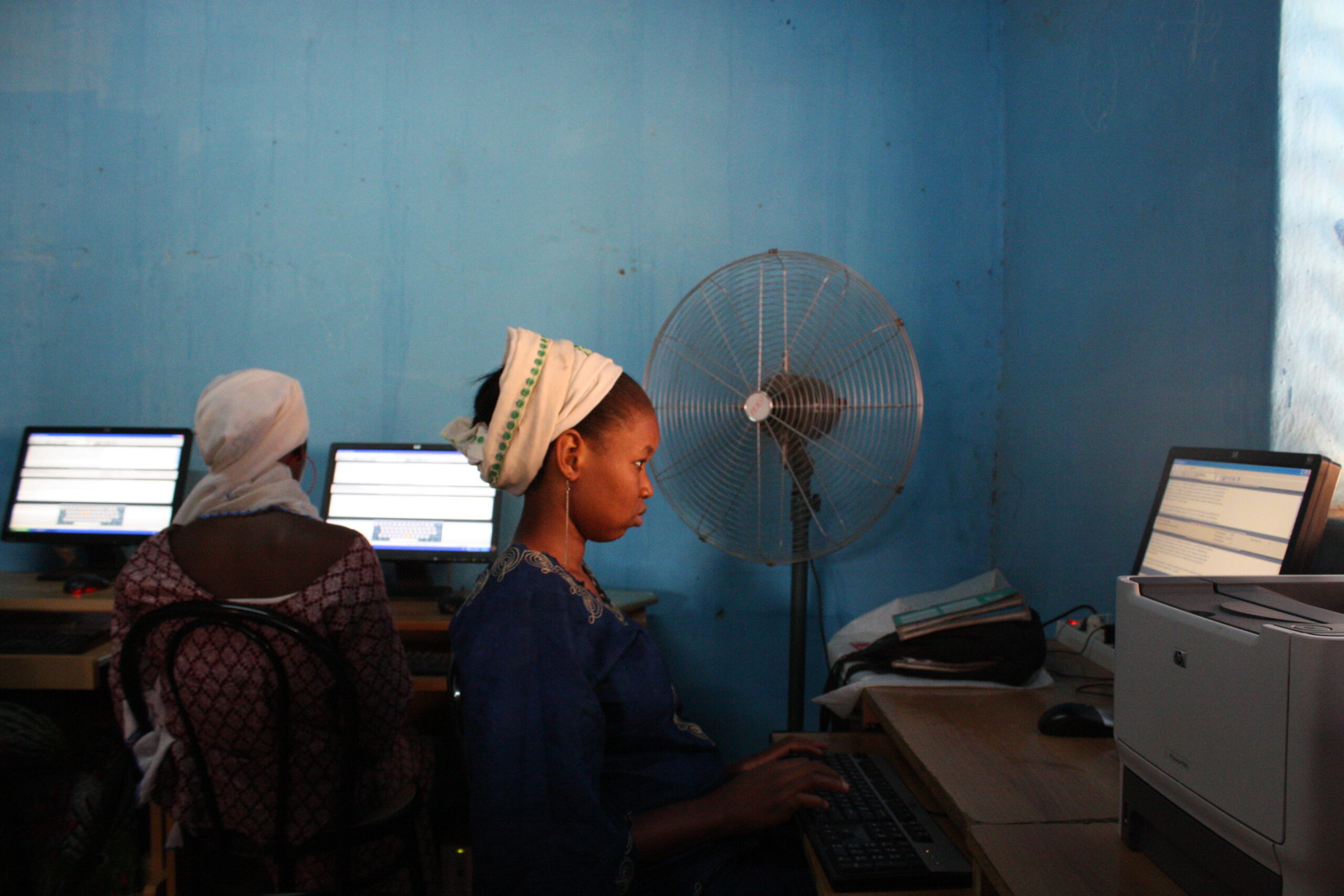 Women and children learn vital IT skills from Islamic Relief at a vocational centre. Niger, 2010.