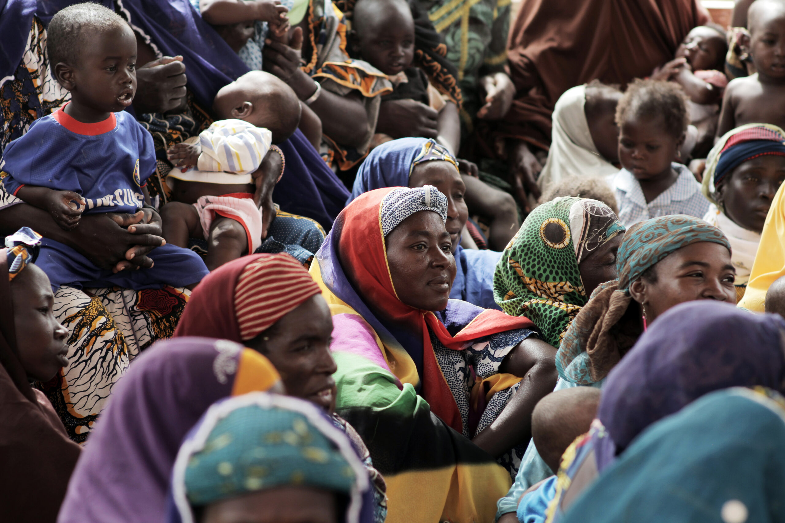 Women and children await their turn at an Islamic Relief Feeding Centre. Niger, 2012.