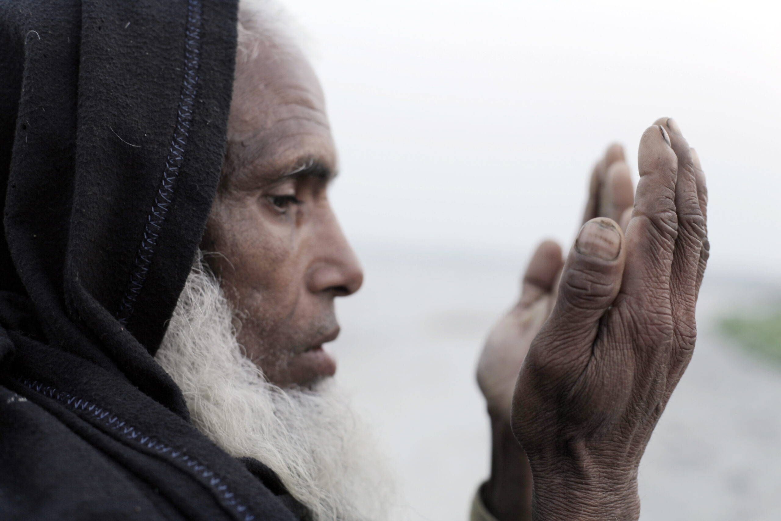 An older man prays during an Islamic Relief Ramadan food distribution. Bangladesh, 2012.
