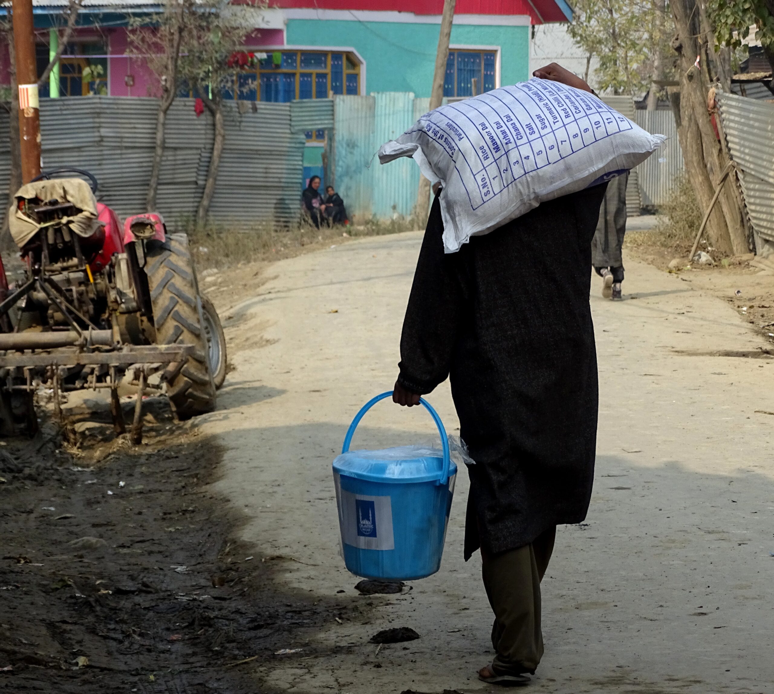 A man carries aid delivered as part of an Islamic Relief flood response. India-administered Kashmir, 2014