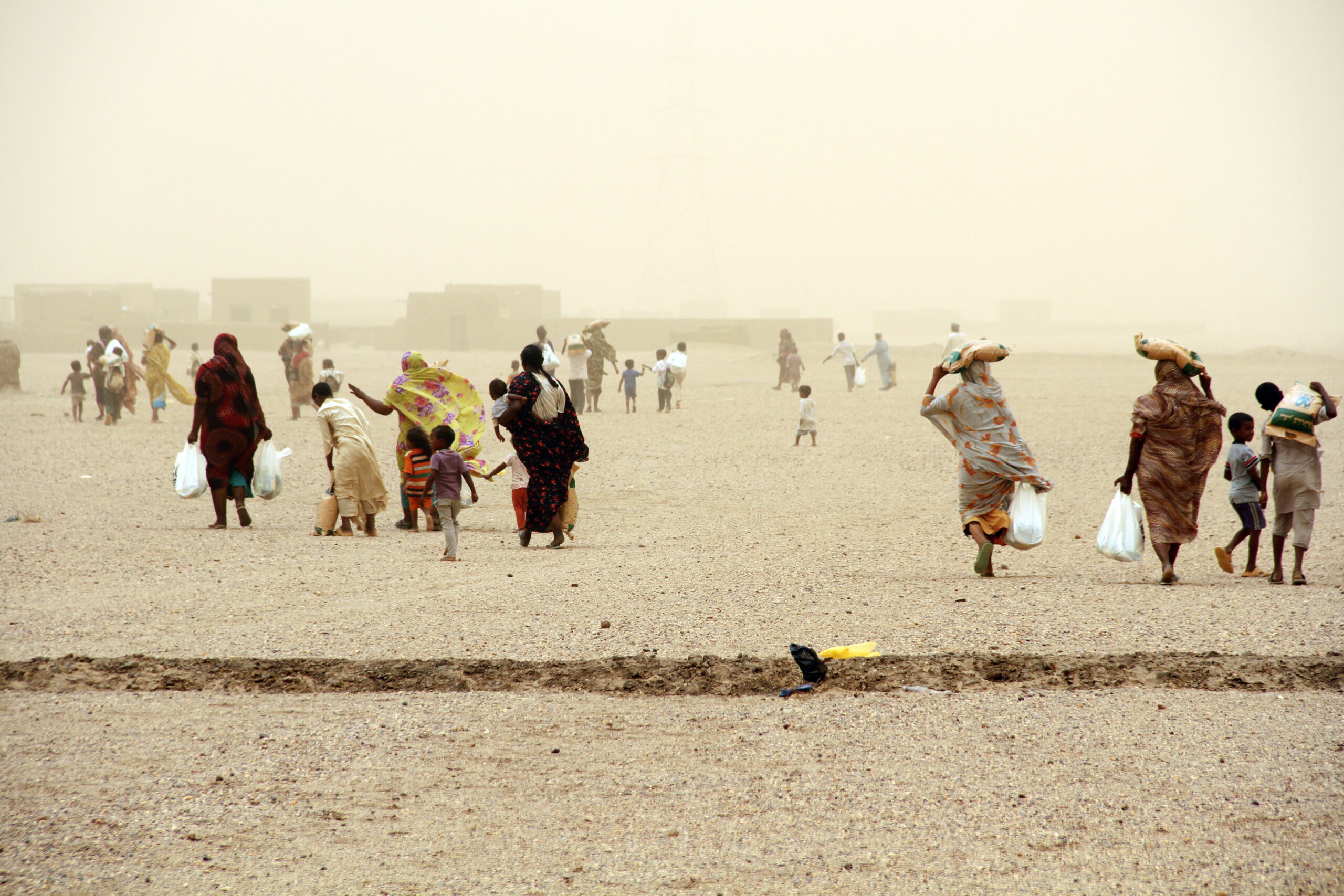 Families return home carrying food received from an Islamic Relief Ramadan distribution. Sudan, 2014.